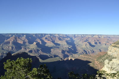 Scenic view of mountains against clear blue sky
