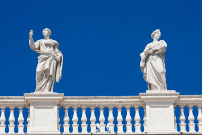 Low angle view of statue against blue sky