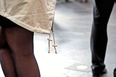 Midsection of woman standing on footpath