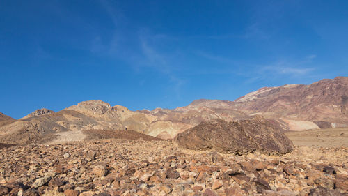 Scenic view of mountains against blue sky