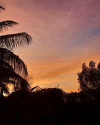 Low angle view of silhouette palm trees against sky during sunset