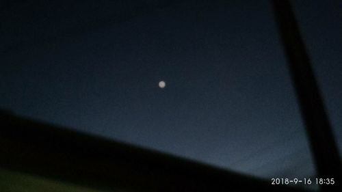 Low angle view of moon against sky at night