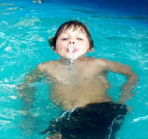 Portrait of girl swimming in pool