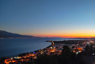 High angle view of illuminated cityscape against sky during sunset