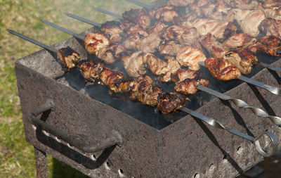 Close-up of grilled meat on barbecue during sunny day