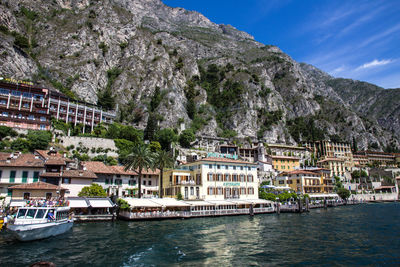 Scenic view of river by buildings against sky