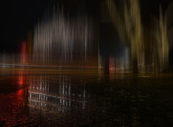View of fountain at night during rainy season