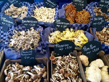 High angle view of mushrooms in containers at market for sale