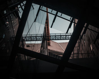 Low angle view of building seen through skylight