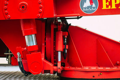 Close-up of red machinery against wall