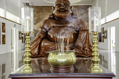 Close-up of buddha statue at home