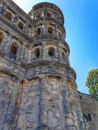 Low angle view of historic tower against clear blue sky