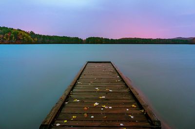 Sunset at sweetwater creek state park, over a wooden dock with fall leavs.