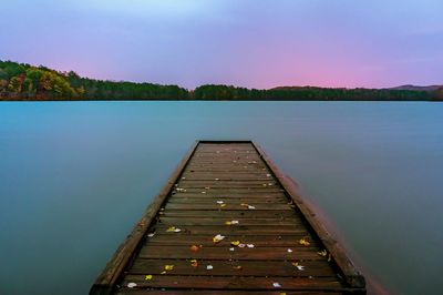 Pier over lake against sky