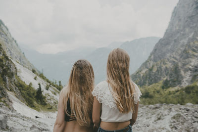 Rear view of two female friends looking at view