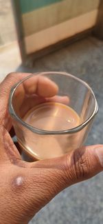 Close-up of hand holding tea cup