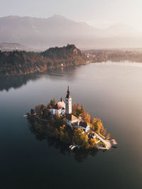 High angle view of church by lake during sunset