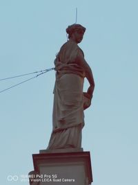 Low angle view of statue against sky