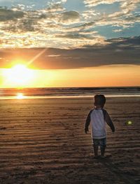 Rear view of boy on beach