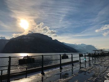 Scenic view of sea by mountains against sky