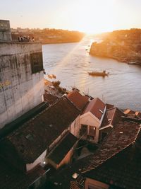 High angle view of buildings by sea against sky