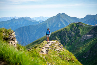 Man looking at mountains against sky