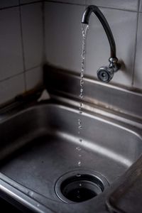 Close-up of water faucet in bathroom