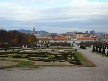 View of buildings in city against cloudy sky