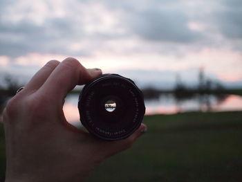 Cropped image of man holding camera