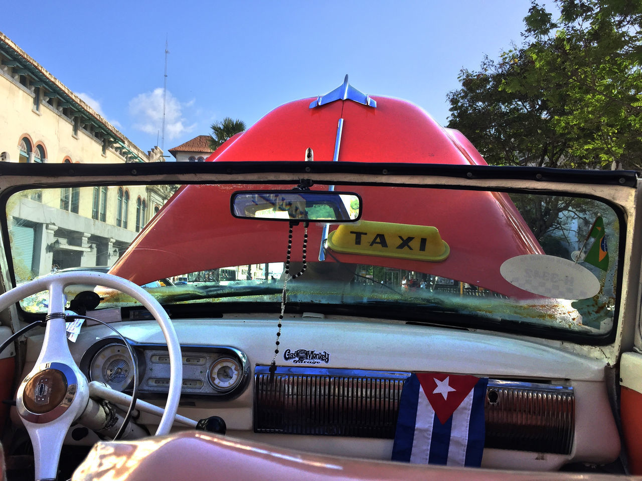 RED VINTAGE CAR ON ROAD