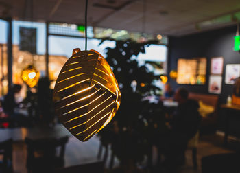 Close-up of illuminated light bulb in cafeteria