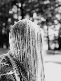 Rear view of woman against tree
