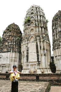 Full length of young man outside temple against building