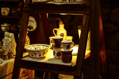 Close-up of crockeries arranged on table in store