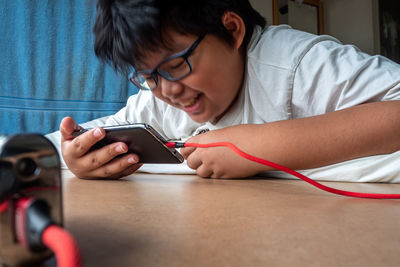 High angle view of boy using mobile phone