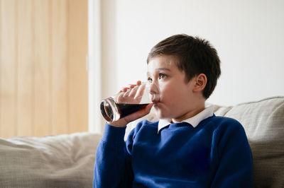 Portrait of boy drinking coffee