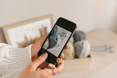 Midsection of man using mobile phone