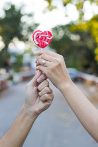 Close-up of woman holding heart shape lollipop