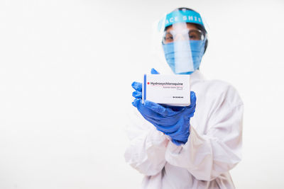 Portrait of person wearing mask against white background