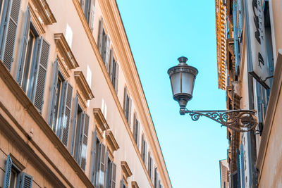 Low angle view of street light against buildings