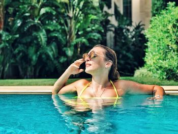 Full length of young woman in swimming pool