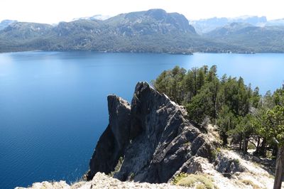 Scenic view of sea and mountains against sky