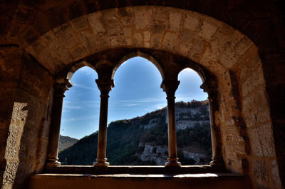 Low angle view of historical building seen through arch window