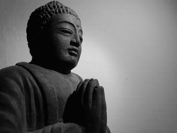 Low angle view of buddha statue against sky