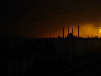 Silhouette of buildings against sky during sunset