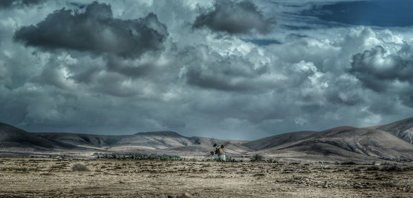Scenic view of arid landscape against sky