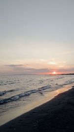 Scenic view of beach against sky during sunset