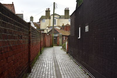 Street amidst buildings against sky