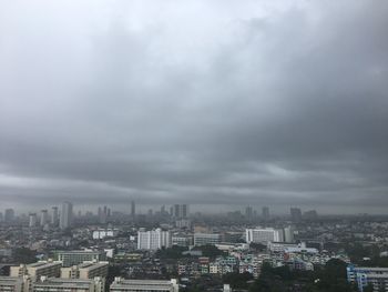 Aerial view of buildings in city against sky