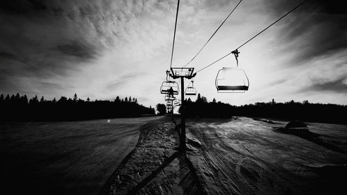 Overhead cable cars against sky